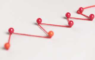Red pins connected by string symbolising the customer journey and identifying points of friction.