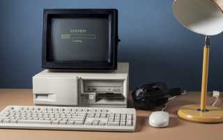 Old desktop computer with a loading screen symbolising outdated legacy communication systems